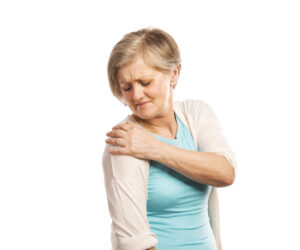 Senior woman with shoulder pain, isolated on white background